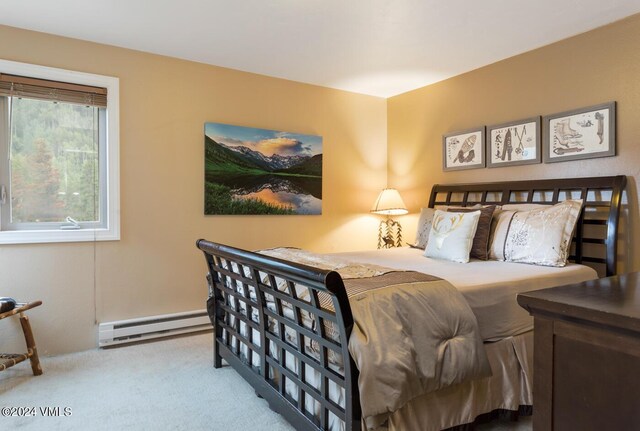 bedroom featuring a baseboard radiator and light carpet