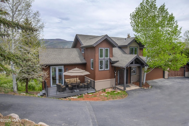 654 Gold Dust Dr W, Edwards, CO 81632 - rustic home with a shingled roof, a wooden deck, and driveway