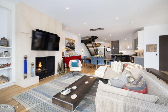 living room with a fireplace and light hardwood / wood-style floors