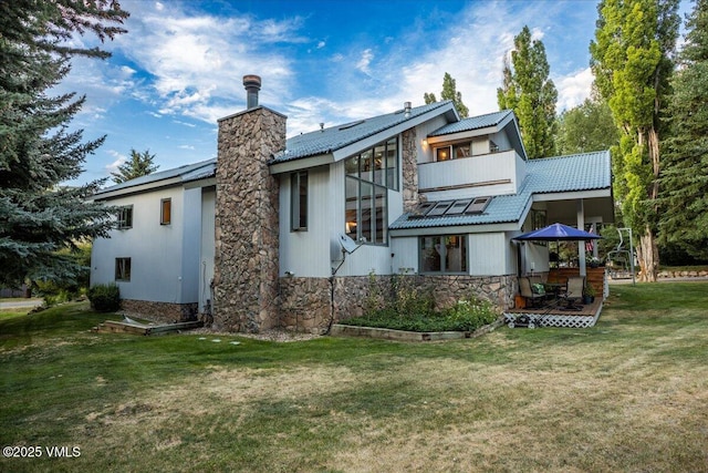 780 Deer Blvd, Avon, CO 81620 - rear view of property with stone siding, a yard, a balcony, and a patio area