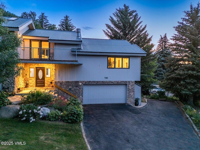 780 Deer Blvd, Avon, CO 81620 - view of front of home with stone siding, driveway, a balcony, a garage, and a tiled roof