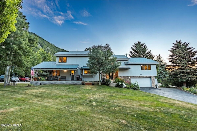 780 Deer Blvd, Avon, CO 81620 - view of front facade with asphalt driveway, a porch, a garage, and a front lawn