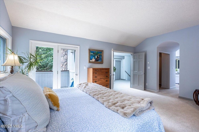 780 Deer Blvd, Avon, CO 81620 - bedroom featuring arched walkways, access to outside, lofted ceiling, carpet, and a textured ceiling