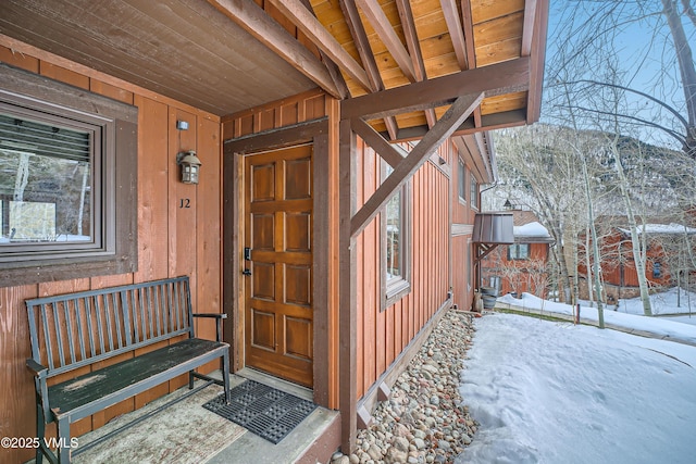 view of snow covered property entrance