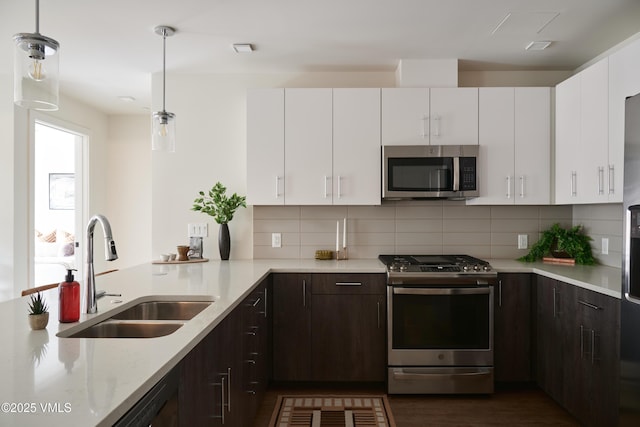 430 S Frontage Rd E Ru-D, Unit Ru-D Vail, CO 81657 - kitchen featuring stainless steel appliances, dark brown cabinetry, backsplash, and white cabinets