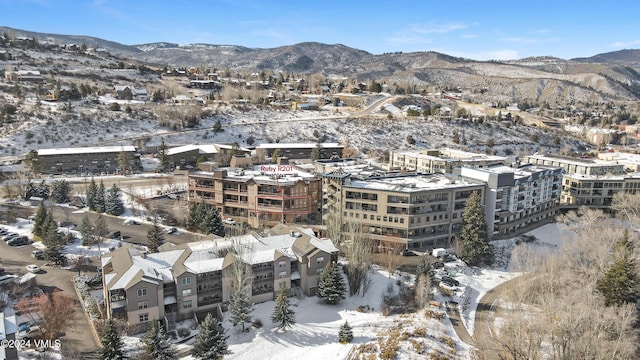 snowy aerial view with a mountain view