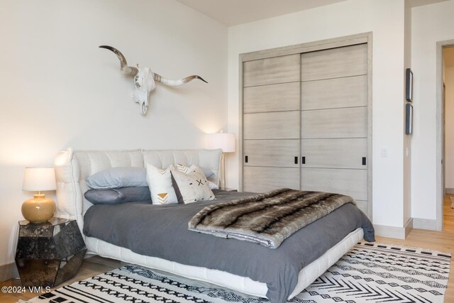 bedroom with hardwood / wood-style flooring and a closet