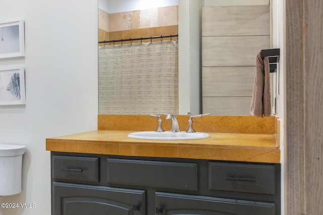 bathroom with vanity, toilet, and a shower with shower curtain