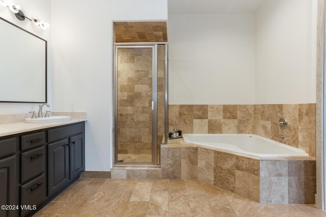 bathroom with independent shower and bath and vanity