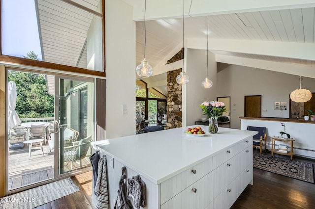 8 Charolais Cir, Edwards, CO 81632 - kitchen with dark wood-style floors, beamed ceiling, a center island, light countertops, and white cabinetry
