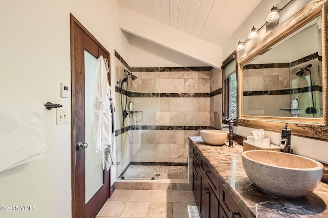 8 Charolais Cir, Edwards, CO 81632 - bathroom featuring a stall shower, double vanity, tile walls, and vaulted ceiling