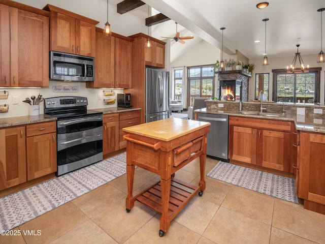 75 Aster Ct, Eagle, CO 81631 - kitchen featuring stainless steel appliances, a fireplace, and brown cabinetry