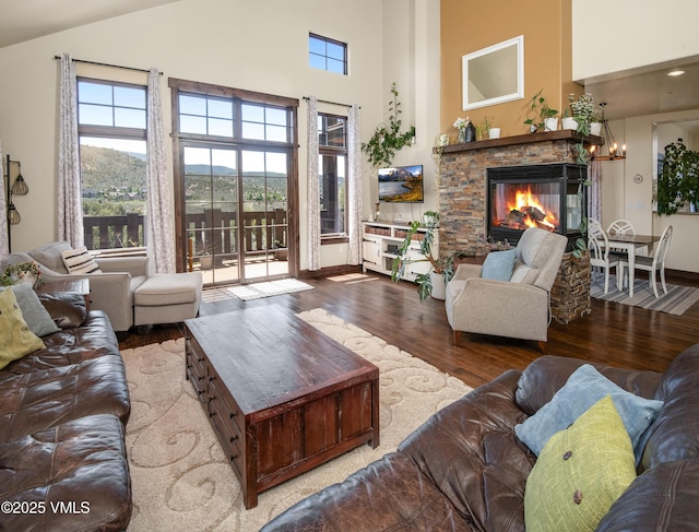 75 Aster Ct, Eagle, CO 81631 - living room featuring a stone fireplace, wood finished floors, and high vaulted ceiling