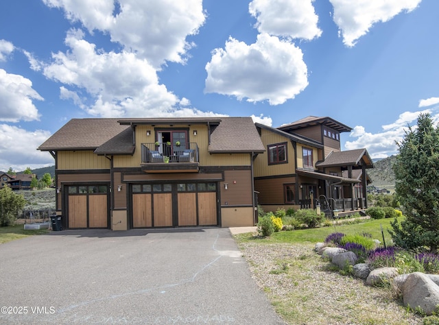 75 Aster Ct, Eagle, CO 81631 - view of front of home with a balcony, a garage, driveway, and roof with shingles