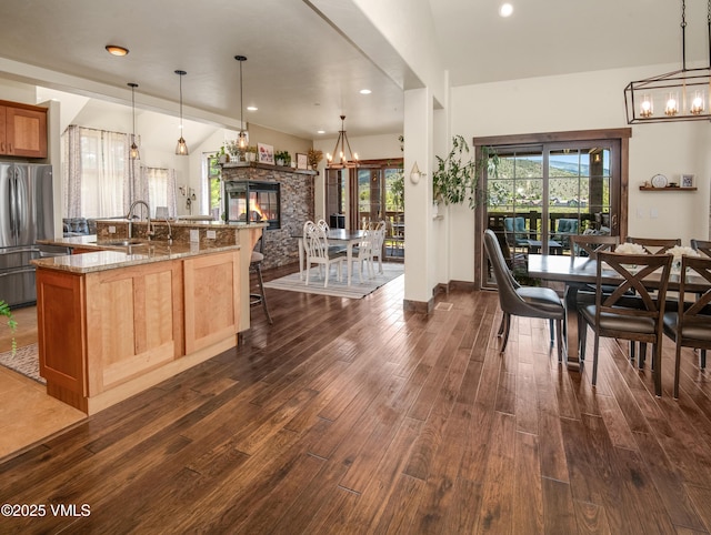 75 Aster Ct, Eagle, CO 81631 - kitchen featuring freestanding refrigerator, a chandelier, dark wood-style flooring, light stone counters, and recessed lighting