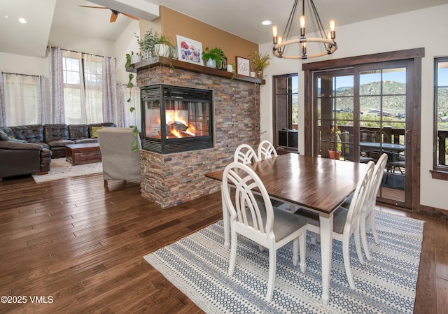75 Aster Ct, Eagle, CO 81631 - dining area featuring dark wood-style floors, a chandelier, a fireplace, recessed lighting, and lofted ceiling