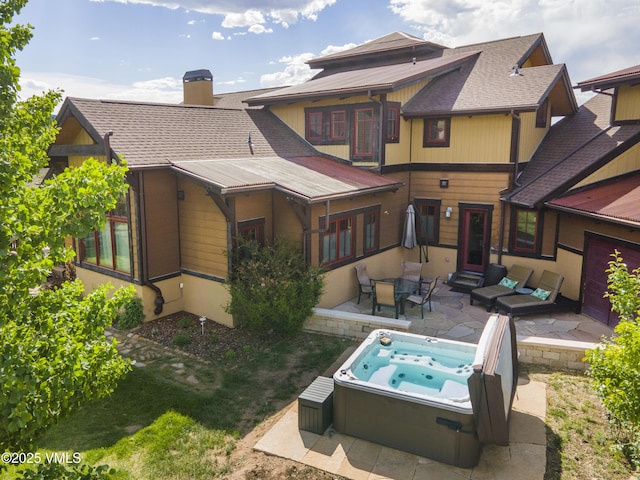 75 Aster Ct, Eagle, CO 81631 - rear view of house with a hot tub, a patio, a shingled roof, and a chimney