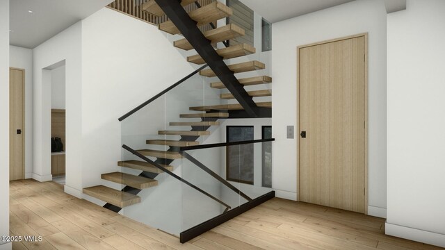 stairs featuring hardwood / wood-style floors