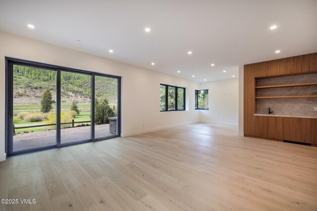 1487 Vail Valley Dr, Vail, CO 81657 - unfurnished living room featuring light wood-type flooring, recessed lighting, and built in features