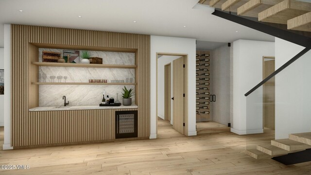 bar featuring stairway, indoor wet bar, backsplash, and light wood-style flooring