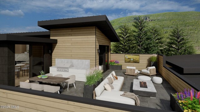 view of patio with an outdoor kitchen, grilling area, and an outdoor living space with a fire pit