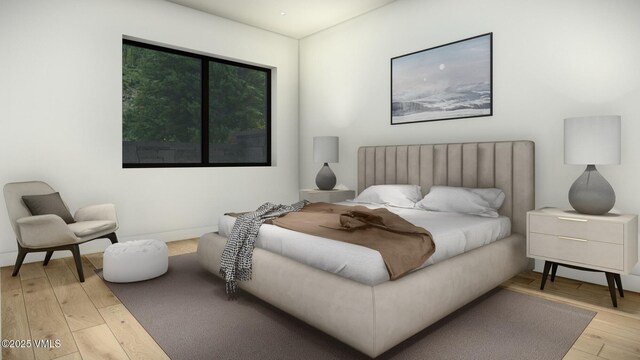 bedroom featuring light wood-style flooring and baseboards