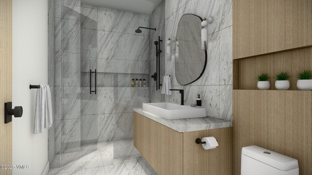 full bathroom with marble finish floor, tiled shower, vanity, and toilet