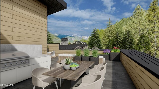 view of patio / terrace with outdoor dining space, grilling area, and a mountain view