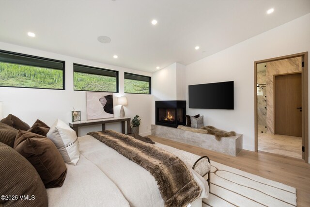 1487 Vail Valley Dr, Vail, CO 81657 - bedroom with wood finished floors, recessed lighting, a multi sided fireplace, and lofted ceiling