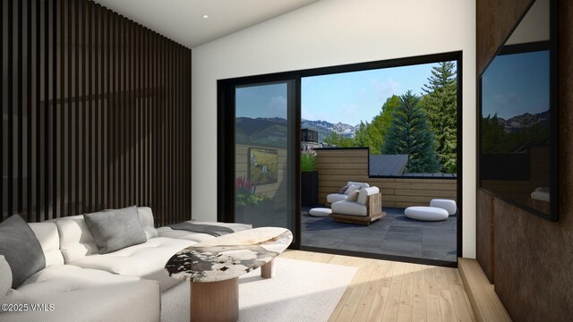 interior space with lofted ceiling, a mountain view, and hardwood / wood-style floors