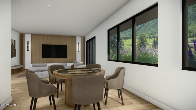 dining area featuring light wood-type flooring and baseboards