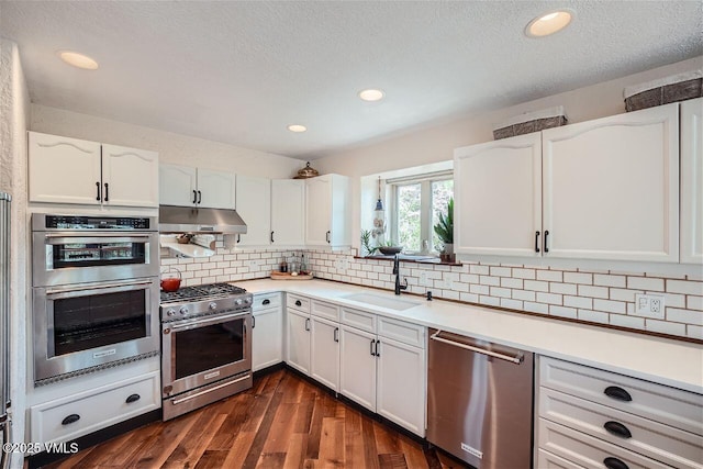 3078 Wildridge Rd Unit D, Avon, CO 81620 - kitchen featuring stainless steel appliances, under cabinet range hood, light countertops, white cabinetry, and recessed lighting