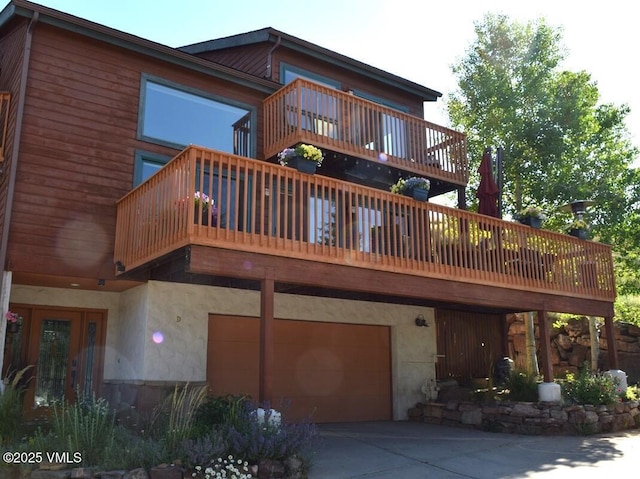 3078 Wildridge Rd Unit D, Avon, CO 81620 - rear view of house with a balcony, a garage, and driveway