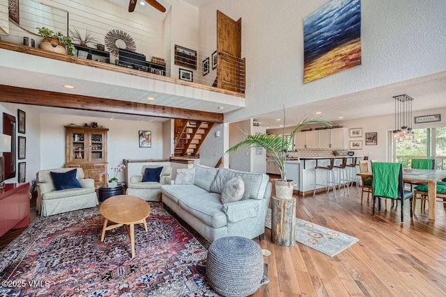 3078 Wildridge Rd Unit D, Avon, CO 81620 - living room featuring hardwood / wood-style floors, a ceiling fan, recessed lighting, stairs, and a high ceiling