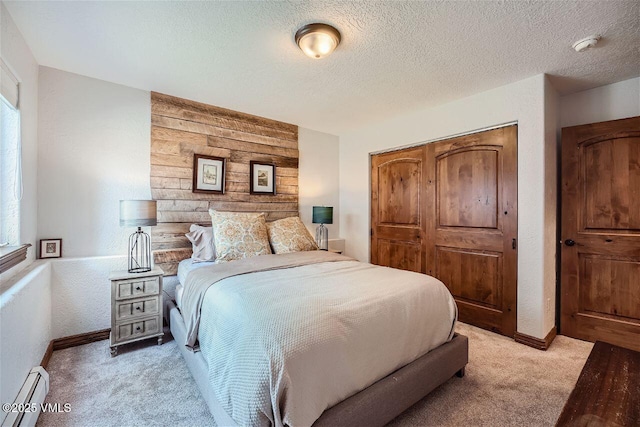 3078 Wildridge Rd Unit D, Avon, CO 81620 - bedroom with baseboard heating, light carpet, a closet, multiple windows, and a textured ceiling