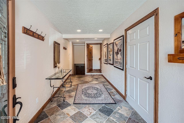 3078 Wildridge Rd Unit D, Avon, CO 81620 - corridor featuring stone finish flooring and a textured ceiling