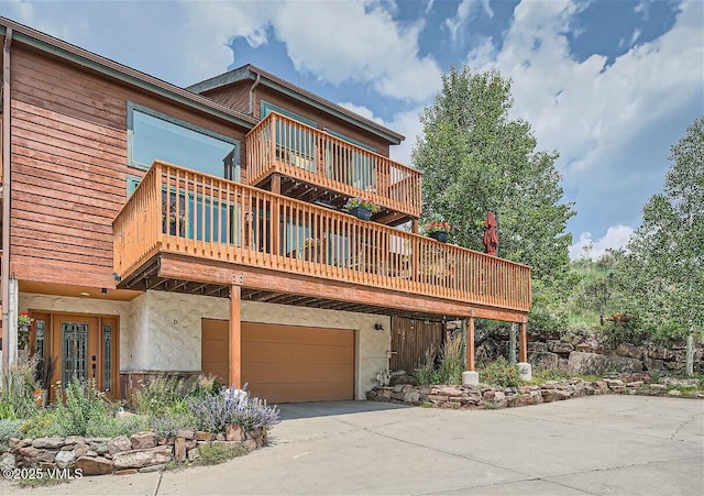 3078 Wildridge Rd Unit D, Avon, CO 81620 - view of front of property featuring concrete driveway, an attached garage, and a balcony