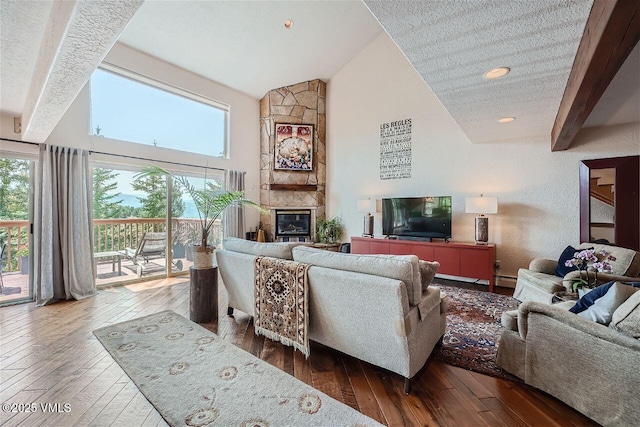 3078 Wildridge Rd Unit D, Avon, CO 81620 - living room featuring wood-type flooring, high vaulted ceiling, healthy amount of natural light, a large fireplace, and recessed lighting