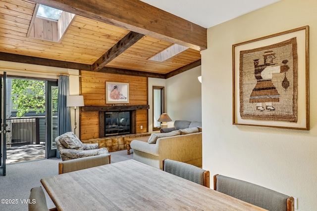 2540 Kinnikinnick Rd Unit G-2, Vail, CO 81657 - carpeted living room featuring a skylight, a wooden ceiling with exposed beams, and a glass covered fireplace