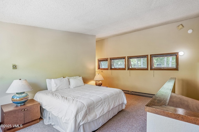 2540 Kinnikinnick Rd Unit G-2, Vail, CO 81657 - bedroom featuring baseboard heating, light colored carpet, and a textured ceiling