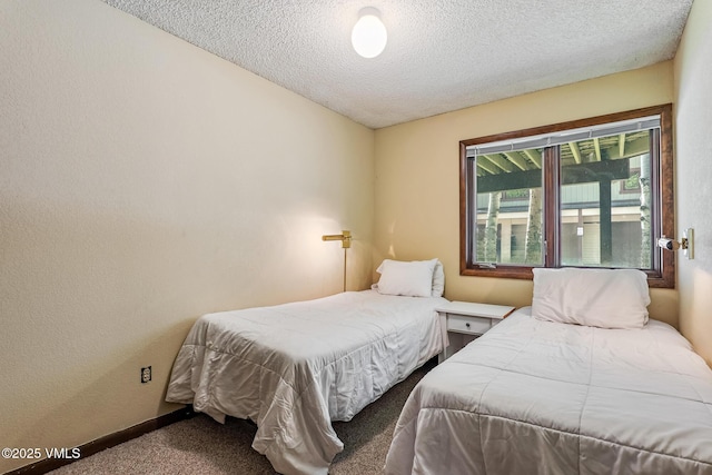 2540 Kinnikinnick Rd Unit G-2, Vail, CO 81657 - carpeted bedroom with a textured ceiling and baseboards