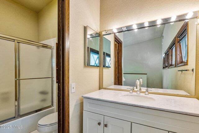 2540 Kinnikinnick Rd Unit G-2, Vail, CO 81657 - full bathroom with vanity, enclosed tub / shower combo, and a textured wall