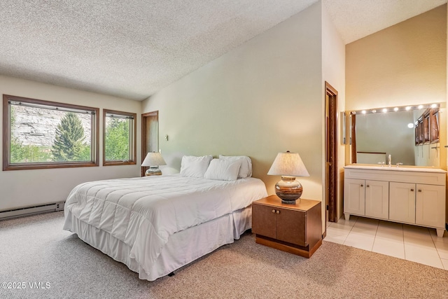 2540 Kinnikinnick Rd Unit G-2, Vail, CO 81657 - bedroom with light colored carpet, a baseboard radiator, a textured ceiling, ensuite bathroom, and vaulted ceiling