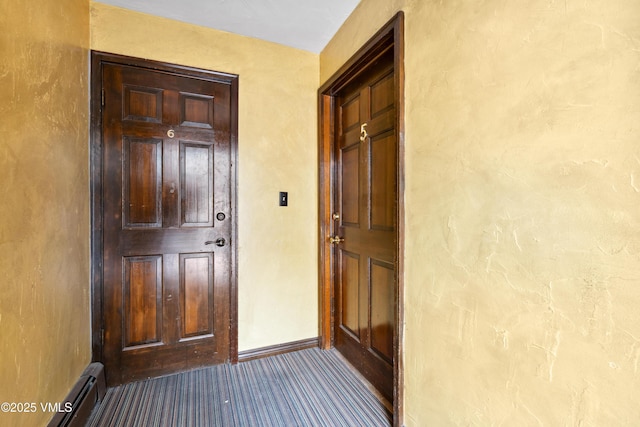 interior space featuring carpet floors, baseboards, and baseboard heating