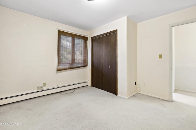 unfurnished bedroom with a closet, a baseboard radiator, baseboards, and carpet flooring