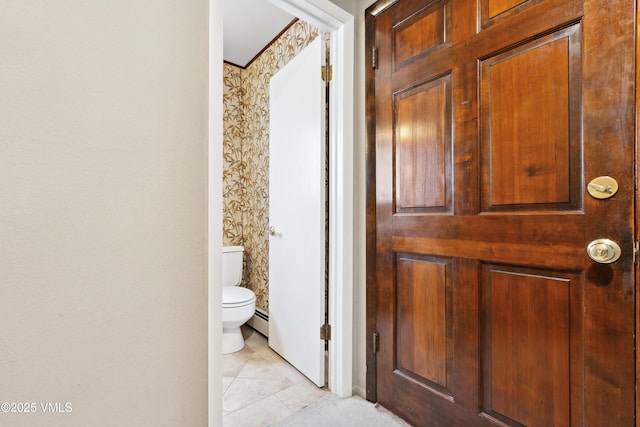interior space featuring light tile patterned floors, a baseboard heating unit, and wallpapered walls