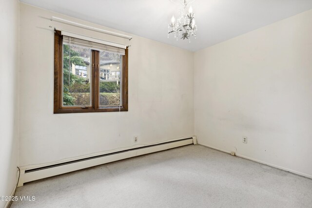 unfurnished room featuring an inviting chandelier, baseboards, baseboard heating, and carpet