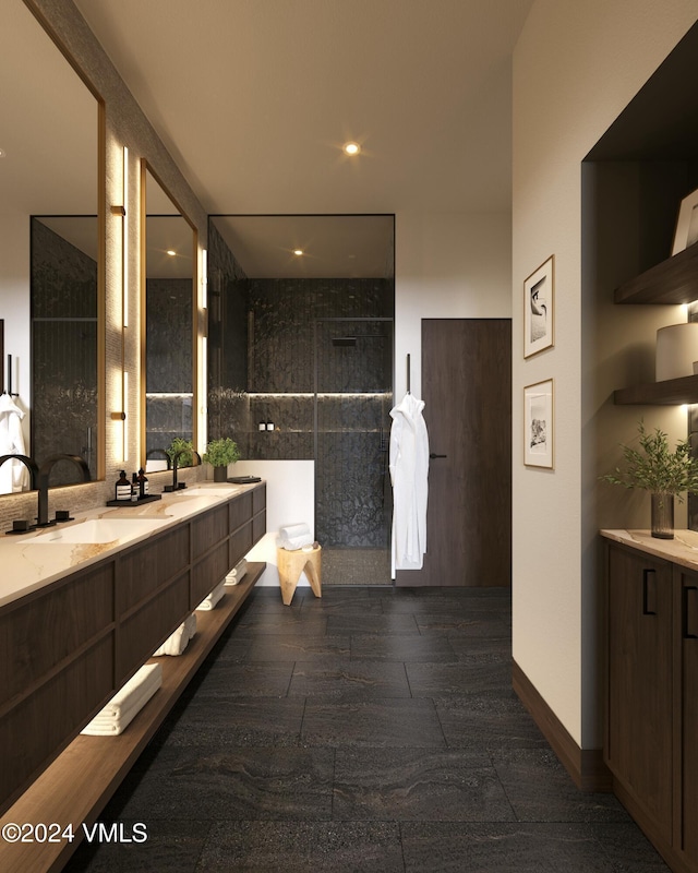 bathroom featuring a walk in shower, double vanity, and a sink