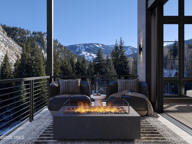 exterior space featuring an outdoor fire pit and a mountain view