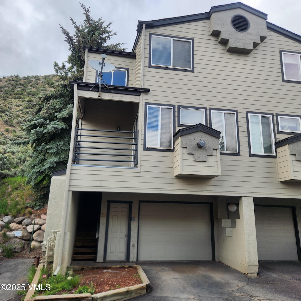 600 Nottingham Rd Unit 15, Avon, CO 81620 - townhome / multi-family property with a balcony, a garage, and asphalt driveway
